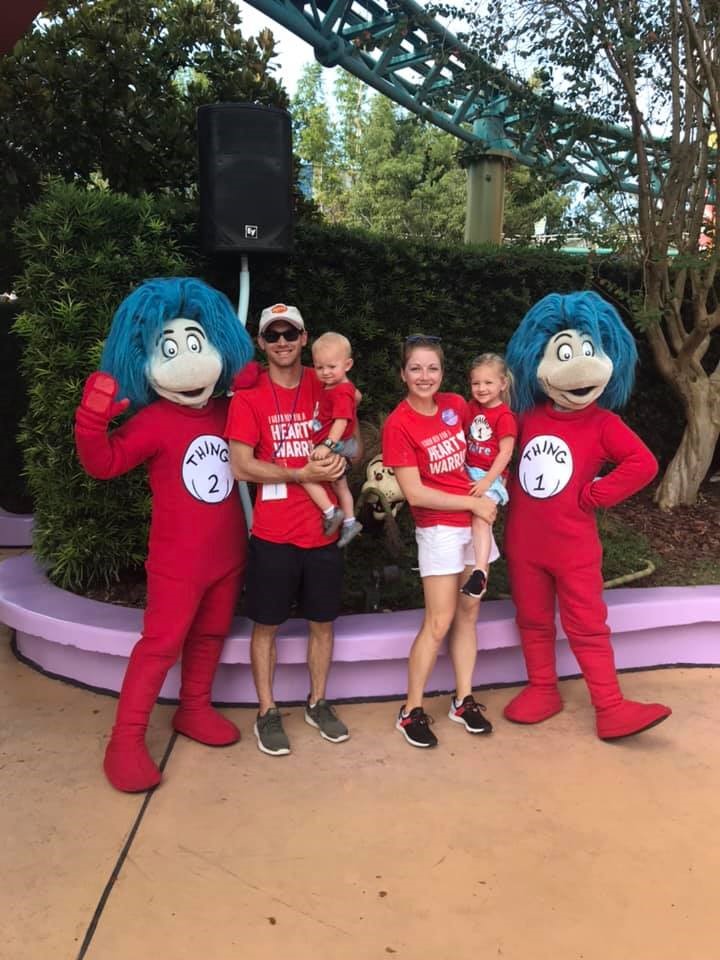 Family at Disney World posing with Thing 1 & Thing 2